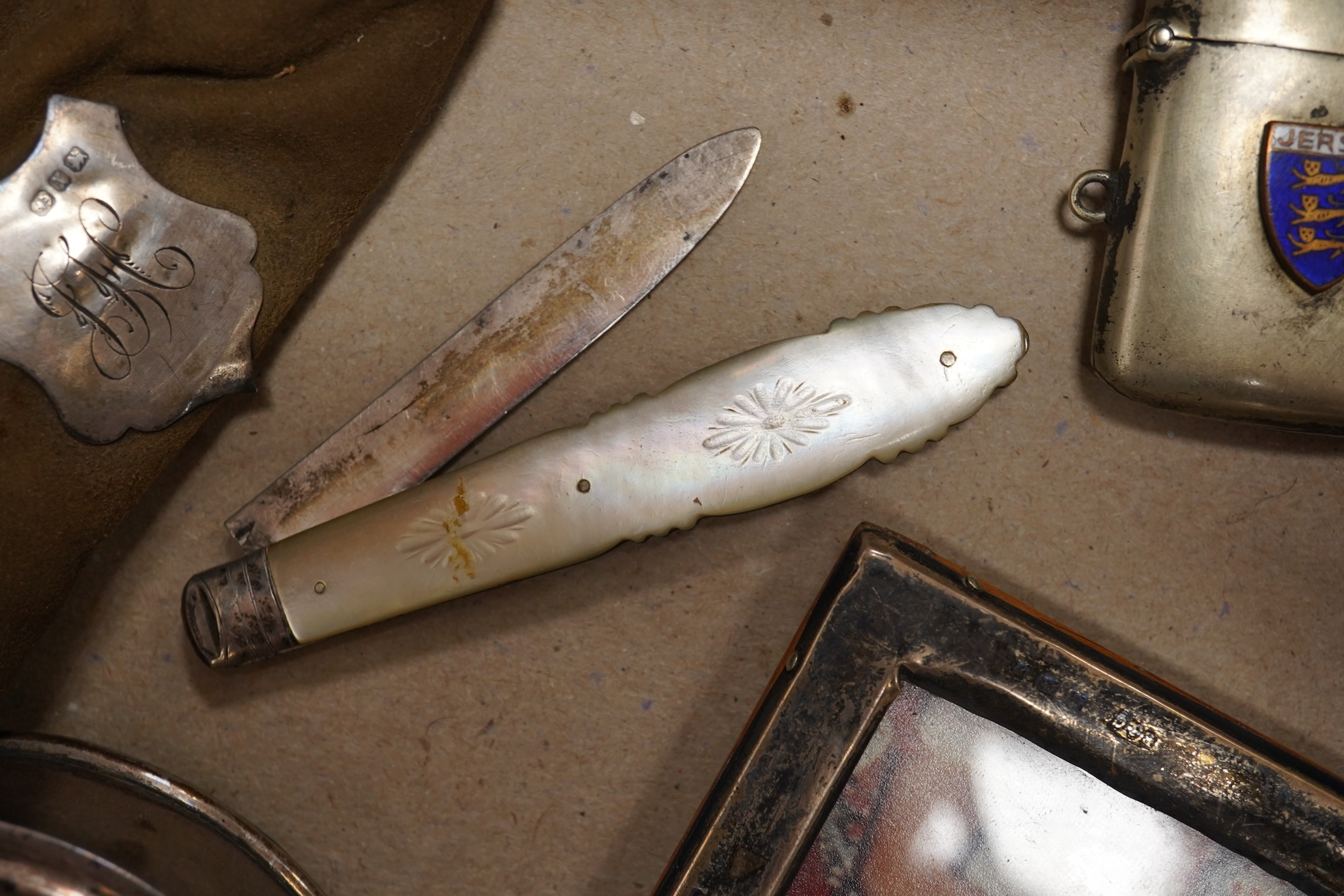 A collection of objects of vertu including snuff boxes, a pair of miniature oval trays, a silver mounted clock and photo frame, etc.